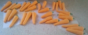 The carrots made out of the extra sugar-paste, with stalks of glacé cherry. 