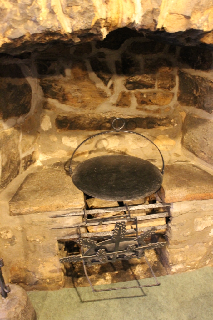A small fireplace and griddle. 